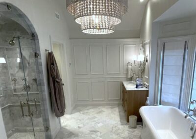 WINN Design - 3x6 marble in Asian Statuary from TileBar with 5x12 profile base skirting pencil chair rail frame subway with double arch vaulted ceiling with 6x12 Asian Statuary as diagonal herringbone marble on floor