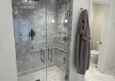 WINN Design - 3x6 marble in Asian Statuary from TileBar with 5x12 profile base skirting pencil chair rail frame subway with double arch vaulted ceiling with 6x12 Asian Statuary as diagonal herringbone marble on floor