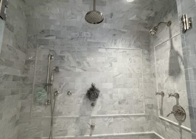 WINN Design - 3x6 marble in Asian Statuary from TileBar with 5x12 profile base skirting pencil chair rail frame subway with double arch vaulted ceiling with 6x12 Asian Statuary as diagonal herringbone marble on floor