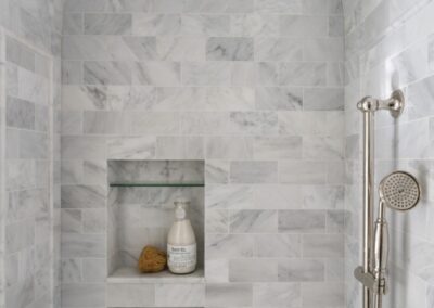 Niches Photo courtesy of WINN Design Houzz- 3x6 marble in Asian Statuary from TileBar with 5x12 profile base skirting pencil chair rail frame subway with double arch vaulted ceiling with 6x12 Asian Statuary as diagonal herringbone marble on floor