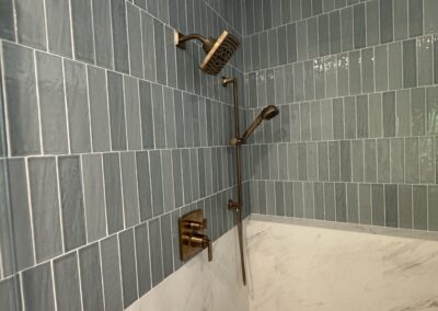24" x 48" Porcelain Luxe White vertically stacked with Marin 2.5" x 10" Ceramic Misty Blue offset 50% with 0.5" x 12" Jolly Trim